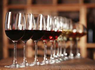 Many glasses of different wine in a row on bar counter