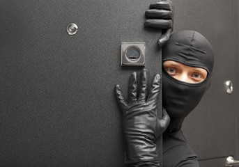 Ninja. Robber hiding behind a door