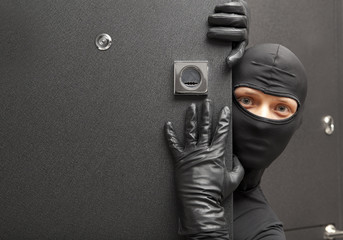 Ninja. Robber hiding behind a door