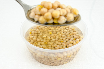 chickpeas on a white background submerged in water