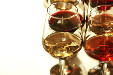 Many glasses of different wine in a row, close up