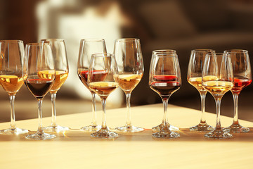 Many glasses of different wine in a row on a table