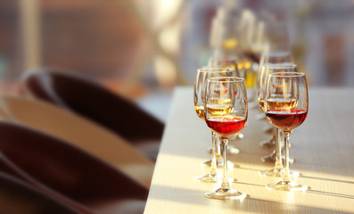 Many glasses of different wine in a row on a table