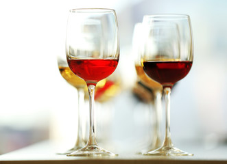 Many glasses of different wine in a row on a table