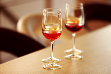 Many glasses of different wine in a row on a table