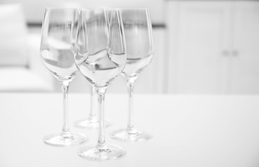 Wineglasses on blurred interior background