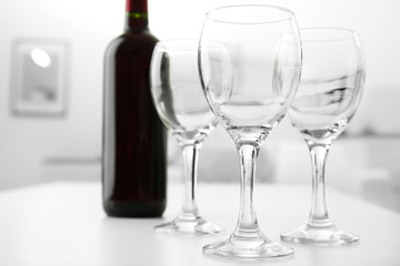 Wineglasses on blurred interior background