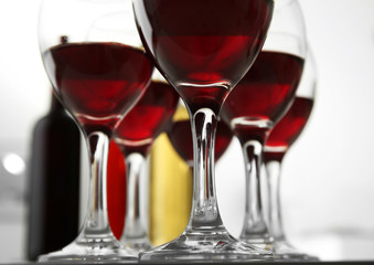 Glasses of red wine on white table closeup