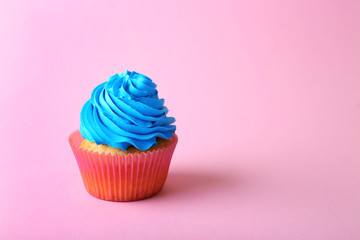 Birthday cupcake on light pink background
