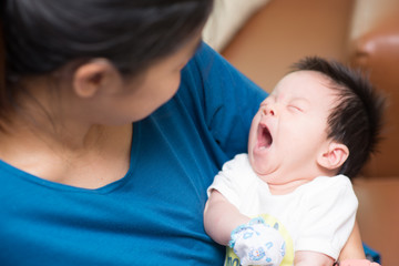 Mother holding her baby looking at face
