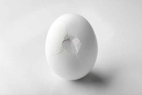Cracked egg on white background