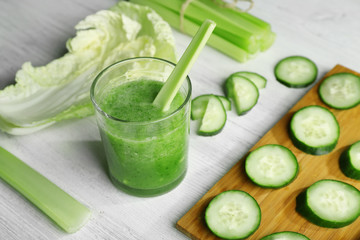 Fresh healthy vegetable smoothie with ingredients on wooden table