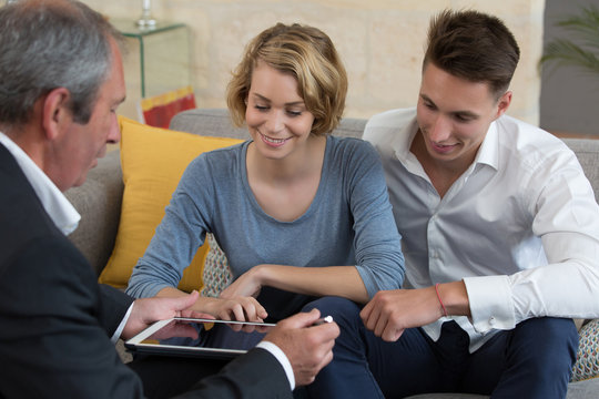 young couple meeting real-estate agent