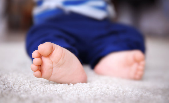 Baby feet on the carpet, close up