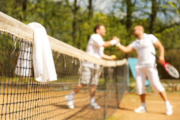 Naklejka na ściany i meble Towels on the tennis nets on the background of the athletes