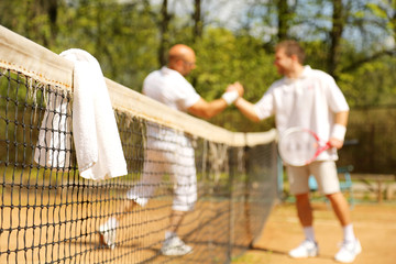 Naklejka na ściany i meble Towels on the tennis nets on the background of the athletes