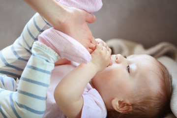 Woman holding small baby hand