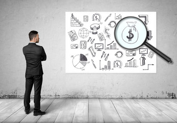 Businessman looking at the bag of money through the magnifier