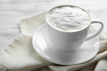 Cup of fresh coffee on napkin