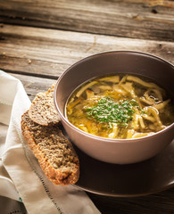 Bowl with  soup  on wooden table.