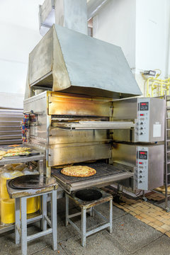Industrial oven for baking pizza. Kitchen Pizzeria
