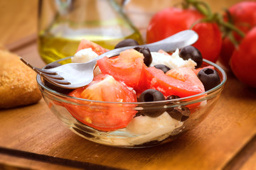 salad bowl with tomato and cheese, selective focus