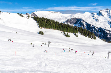 Fototapeta na wymiar Snow slope in mountain with small slopes for beginners. Ski resort in Alps Switzerland, ''Jungfrau''. 