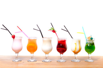 Cocktails on a white background. Various cocktails on a wooden table