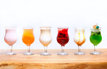 Cocktails on a white background. Various cocktails on a wooden table