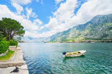Fototapeta na wymiar Harbour and boat at Boka Kotor bay (Boka Kotorska), Montenegro, Europe.