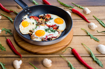 Fried eggs with peppers and mushrooms