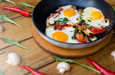 Fried eggs on a wooden background