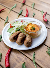 Delicious grilled burgers served with fresh salad
