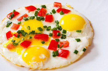 fried eggs with vegetables on plate