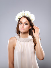 Portrait of a beautiful woman with flowers in her hair. Fashion