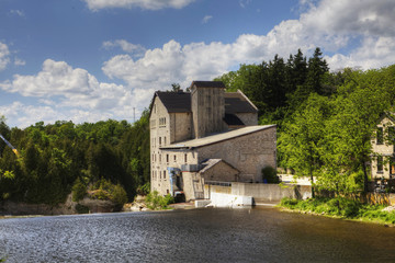 Obraz premium The old mill in Elora, Canada on a sunny day