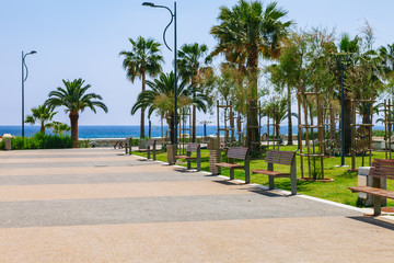 Fototapeta premium Coastline and promenade in Limassol, island Cyprus, Europe, Mediterranean Sea. Bright sunny day and blue water and sky.