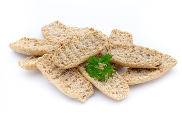 Dry flat bread crisps with herbs on a white background.
