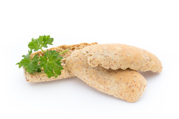 Dry flat bread crisps with herbs on a white background.