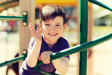 Obraz premium happy little boy climbing on children playground