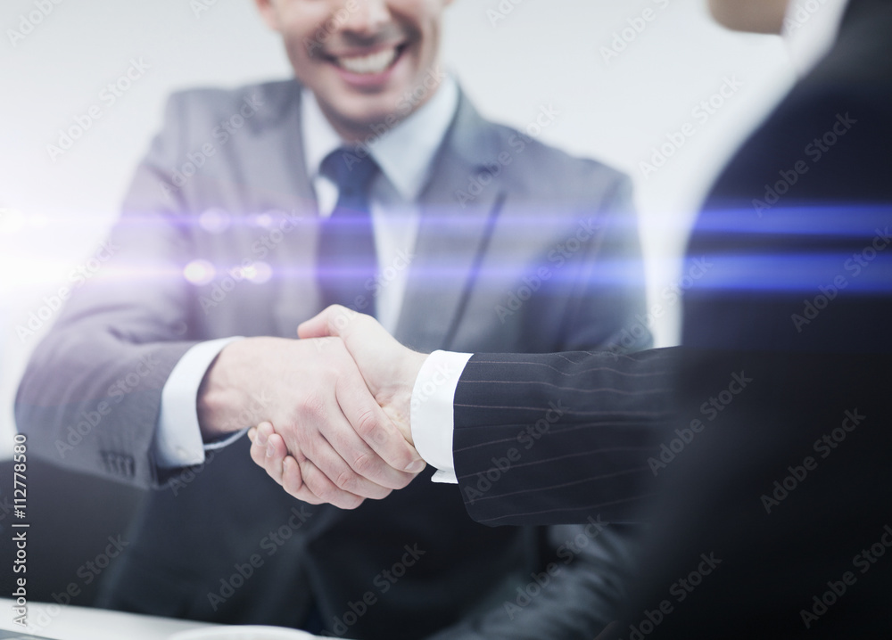 Poster two businessmen shaking hands in office