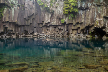 Fototapeta na wymiar First tier of the Cheonjeyeon Falls on Jeju Island in South Korea.