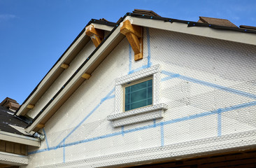 Fototapeta na wymiar Home building industry double gable roof prep for stucco