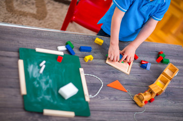 Child boy playing with toys at table