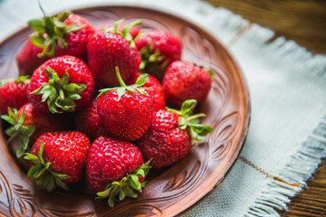 Ripe strawberry on a plate, the top view. Berries.