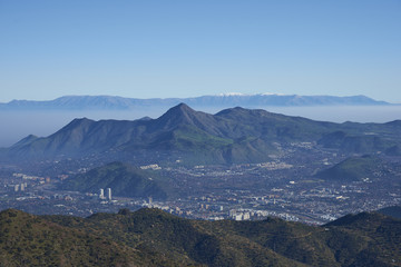 Obraz premium Panoramic view of Santiago, capital of Chile. Viewed from Parque Puente Nilhue in the foothills of the Andes Mountains looking towards Cerro Manquehue (1,635m).