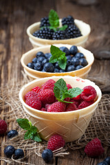 Blackberries, raspberries and blueberries in a waffle bowls.