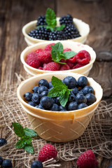Blackberries, raspberries and blueberries in a waffle bowls.