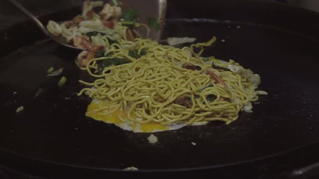 tasty seafood omelet on the pan 