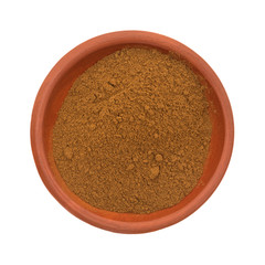 Bowl of cinnamon spice on a white background top view